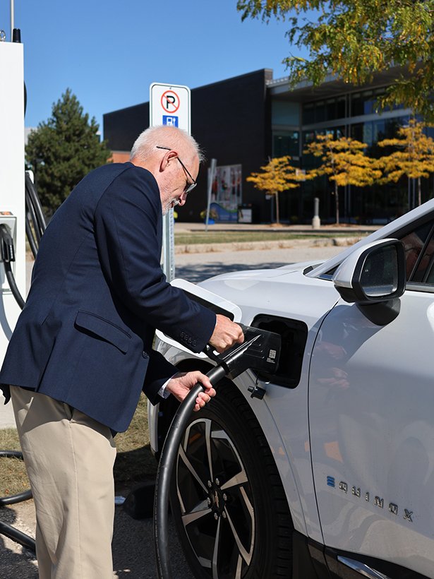 Mayor Foster charging a electric vehicle.