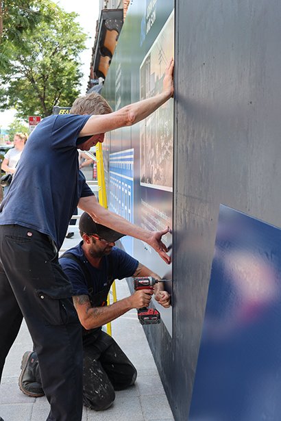 Clarington staff installing the mural.