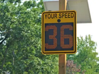 Radar message board with digital screen showing kilometre speed.