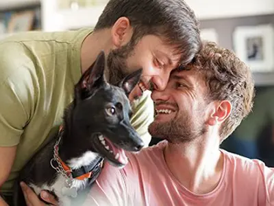 A couple at home with their adopted dog.
