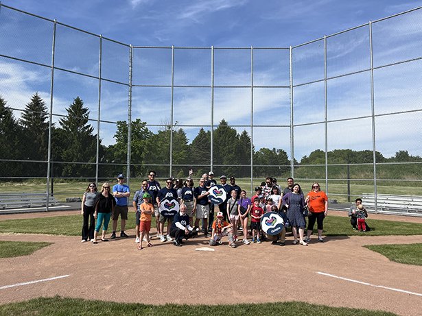 (From left to right) Residents joined Lloyd Rang, Councillor, Ward 2; Sami Elhajjeh, Councillor, Ward 1; Adrian Foster, Mayor; Margaret Zwart, Councillor, Ward 4; Willie Woo, Regional Councillor, Wards 3 and 4; Granville Anderson, Regional Councillor, Wards 1 and 2; and Corinna Traill, Councillor, Ward 3; for a ribbon-cutting and celebratory first pitch on the new tournament-grade hardball diamond at Newcastle Community Park.