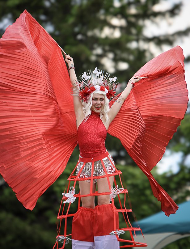 Stilts performer dressed in a red and white costume for Canada Day.