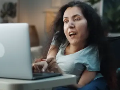 A wheelchair user using a laptop.