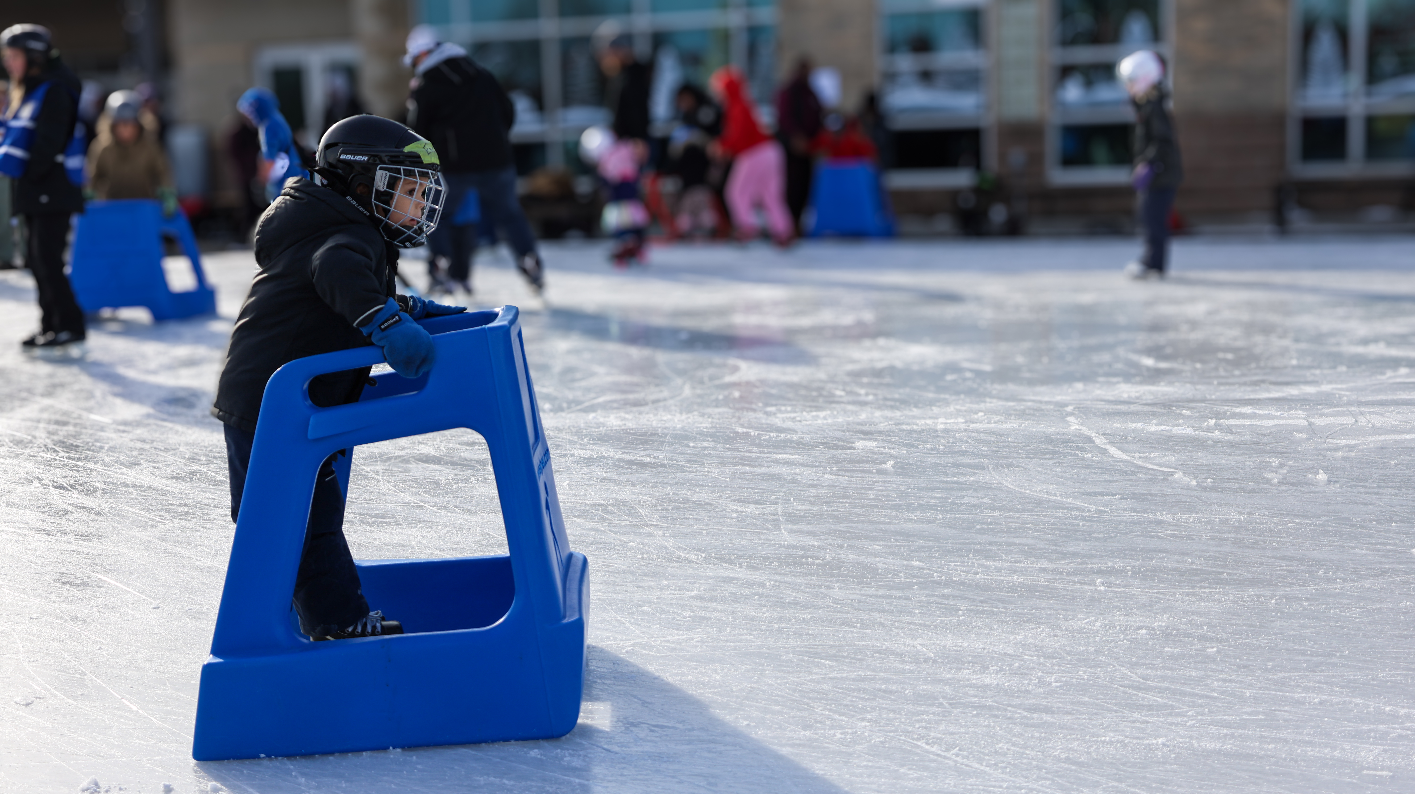 Child using a skate aid at the Mayor's Levee 2025.