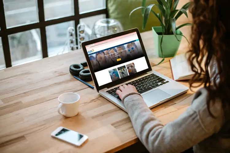Woman on a laptop looking at Clarington Active.