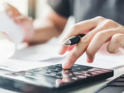 Close up of an individual using a calculator.