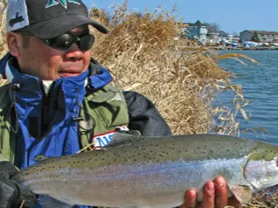Man holding a fish he just caught.