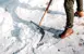 Close up of someone shovelling their sidewalk.
