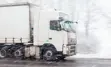 A large truck on a wintery street.