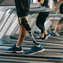 A person with a prosthetic leg running on the treadmill.
