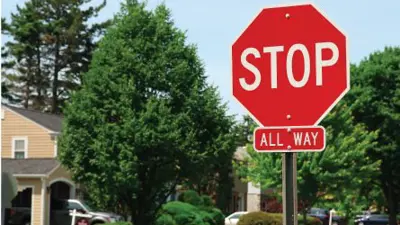 Stop sign at a neighbourhood intersection.