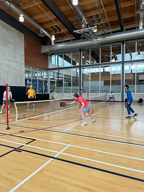 Residents playing pickleball in the gym at Diane Hamre Recreation Complex