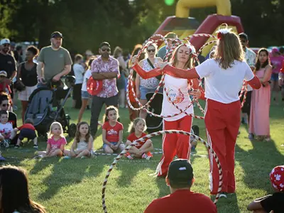 Hula hoop performer perform a routine for a captive audience