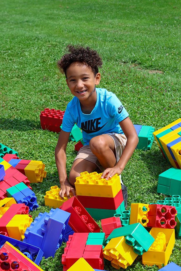 A boy plays with large building blocks.