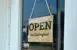Open in Clarington sign hanging in a business front door window. 
